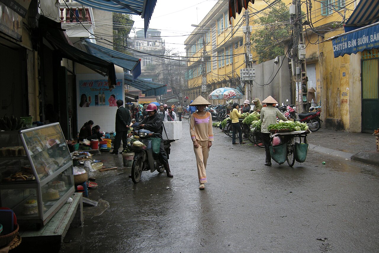 Atmospheric narrow street scene with merchant shophouses in Hanoi Old Quarter