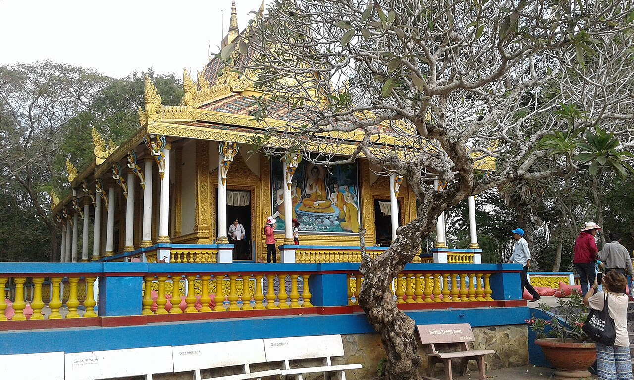 Ornate gilded sanctum and curved tiled roof of Chua Doi Bat Pagoda in Soc Trang