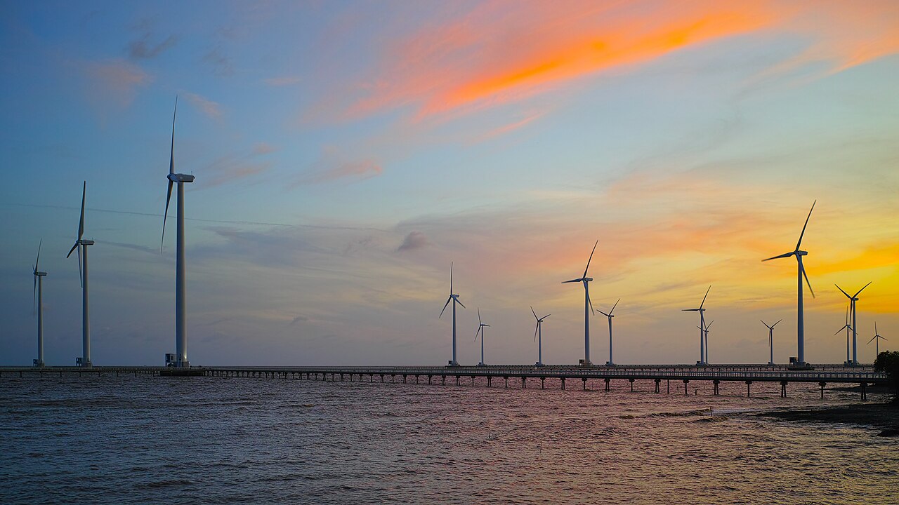 Offshore wind turbine farm extending across coastal mudflats into the sea in Bac Lieu