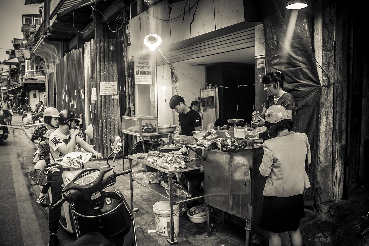 Busy Vietnamese street food stall with visible preparation