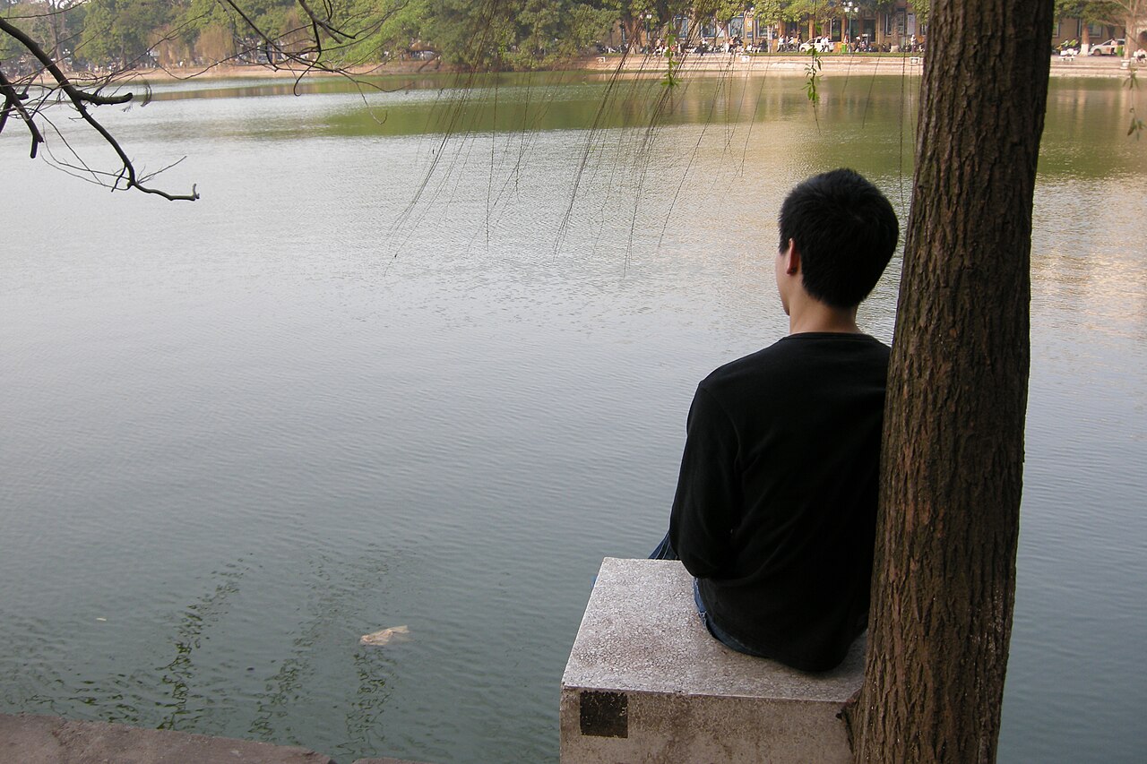 Tranquil emerald waters and verdant willow trees around Hoan Kiem Lake in central Hanoi