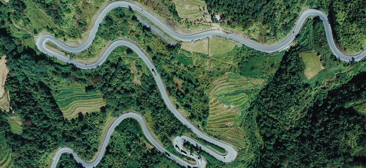 Aerial view of the winding mountain switchbacks along the Ma Pi Leng Pass in Ha Giang, Vietnam